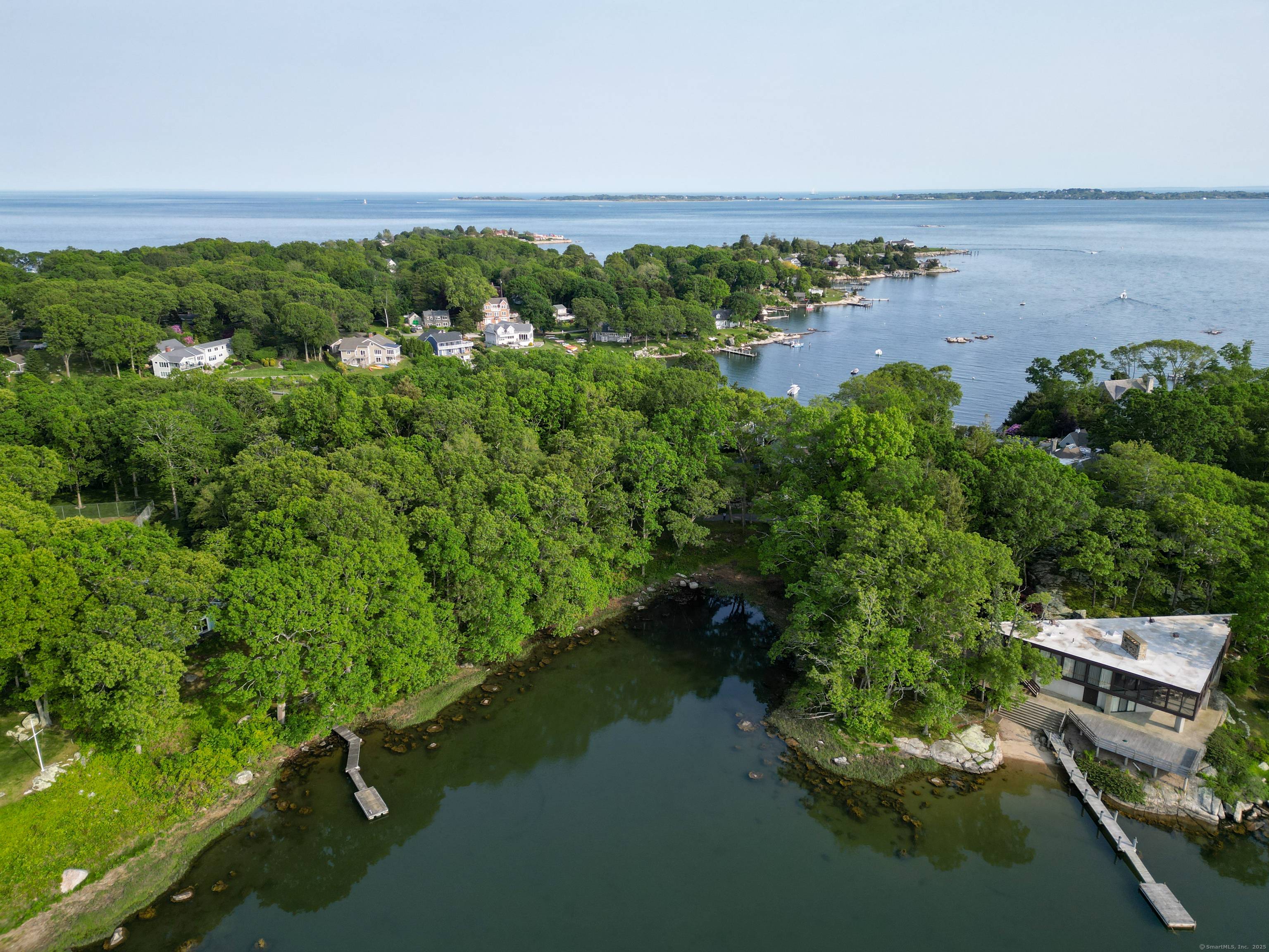 Beautiful waterfront building lot with approved house plans within the Masons Island Private Association located at the southern end of the island.