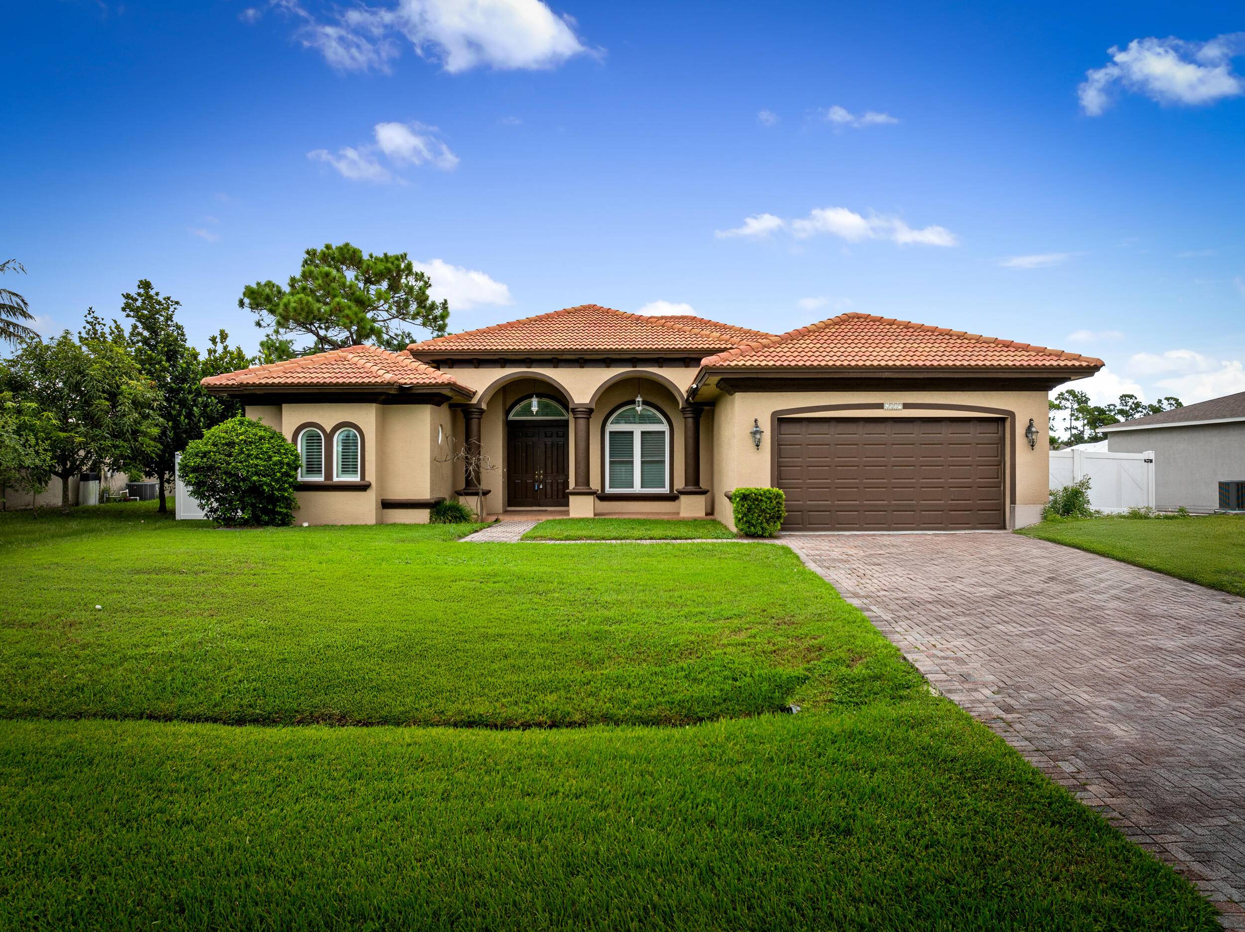 Elegant 4BR 3BA home with 2, 710 sq ft of living space, soaring 10 12 ft ceilings, tray ceilings, extra wide crown molding, and 8 ft doors throughout.