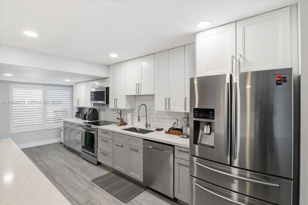 Spacious lakefront townhome offering the feel of a single family residence within the well established Trellises community in Plantation.