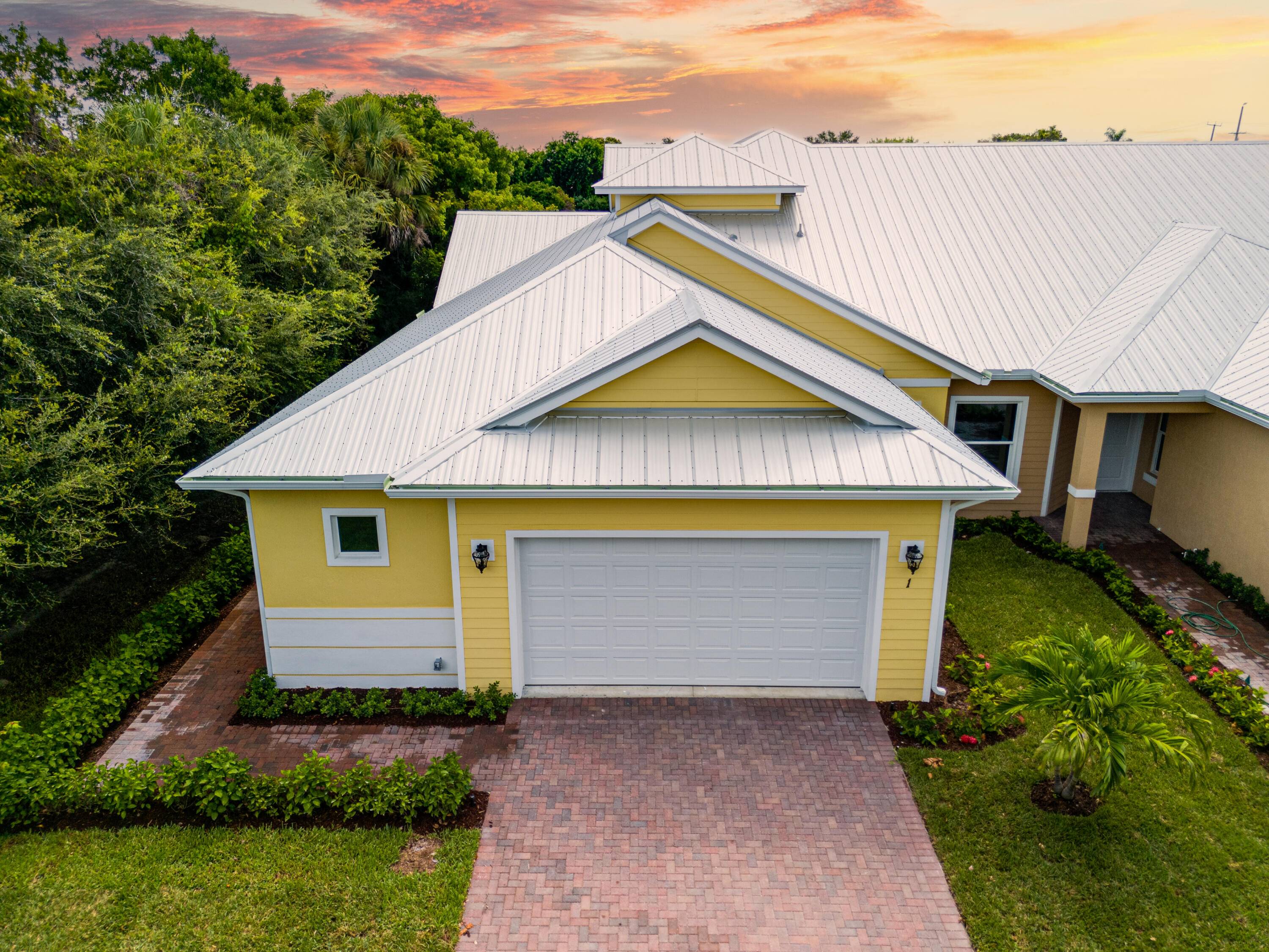 Experience luxury in this 2 story corner unit with a sleek metal roof, oversized garage, and elegant finishes throughout.