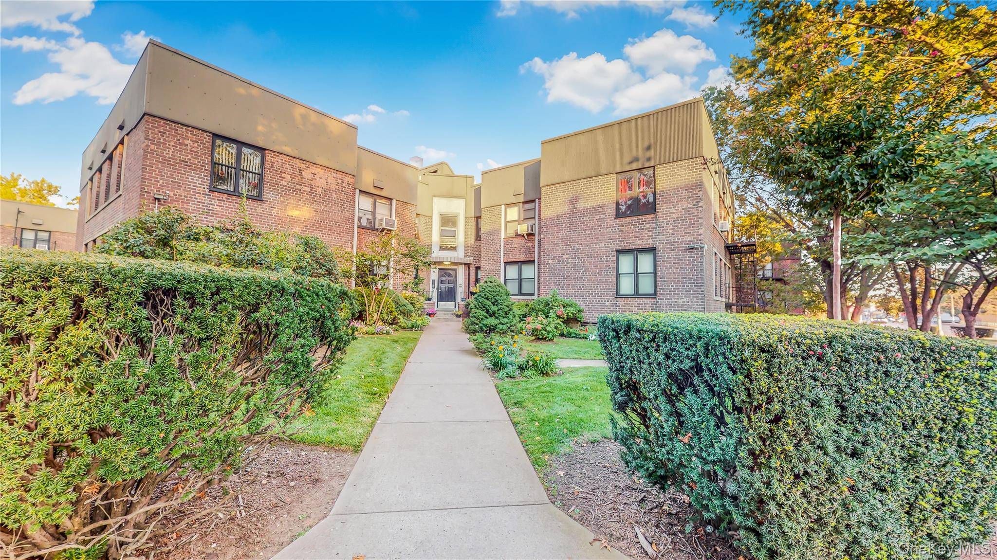 Comfort and convenience meet in this East Elmhurst home, where hardwood floors, a renovated bathroom, and an updated kitchen create a welcoming setting.