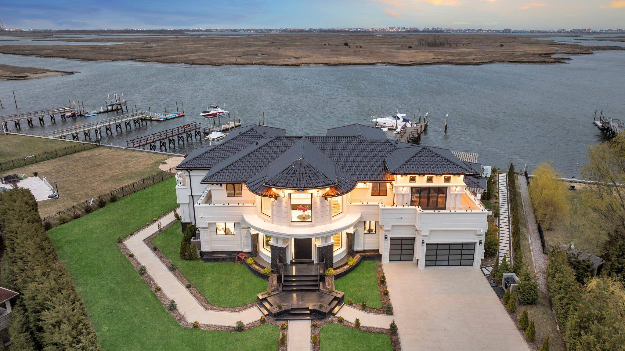 Welcome to 190 Curtis Road, a newly constructed 9, 200 sq ft luxury modern residence located on a cul de sac in Hewlett Neck, offering panoramic views of Brosewere Bay, ...