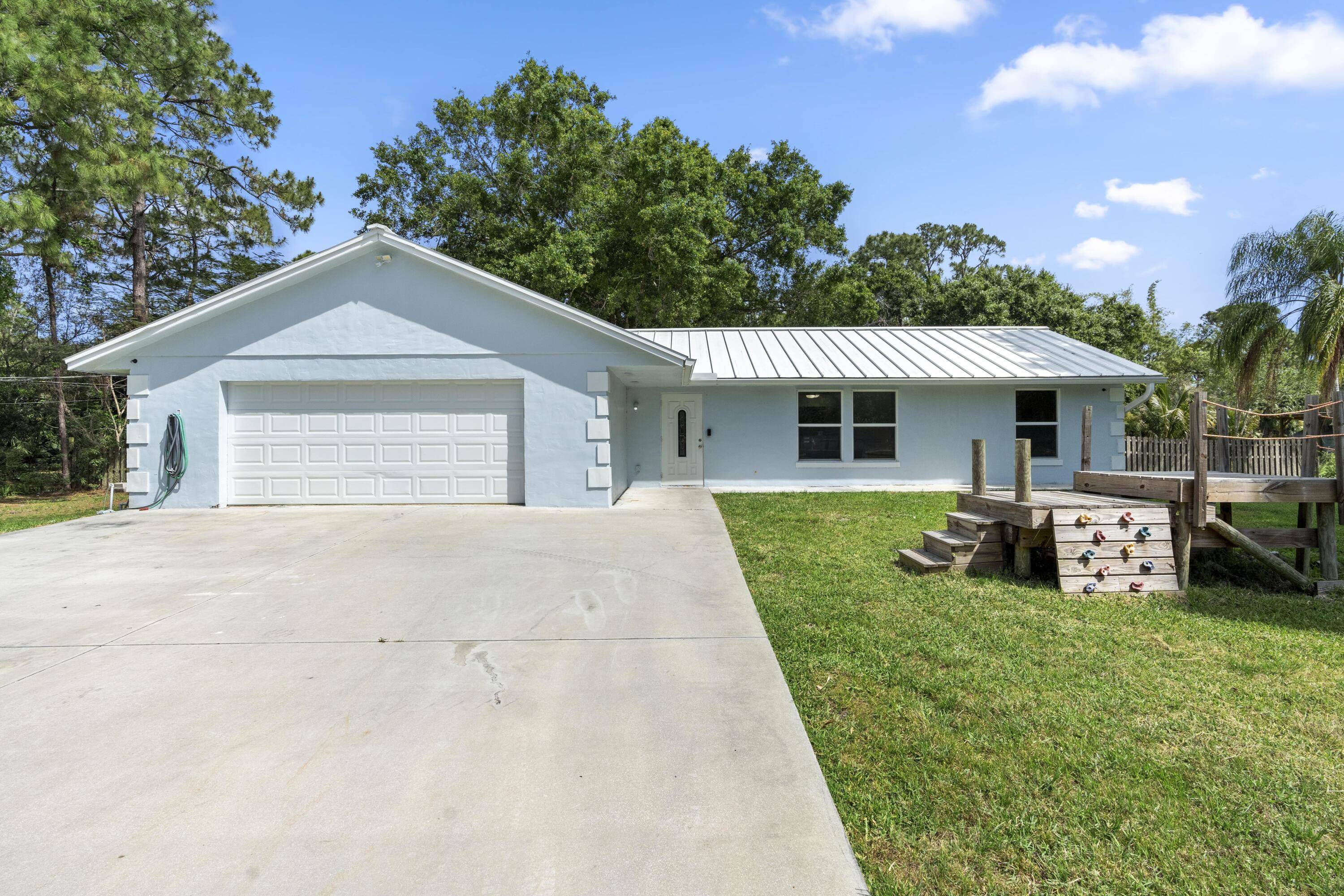 This 4 bedroom, den, 2 bathroom Jupiter Farms home offers the perfect canvas for creating your dream home in a serene and peaceful setting on 1.