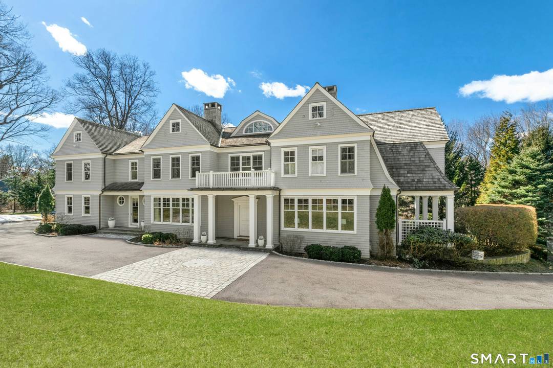 Situated proudly on a knoll near the center of town, this beautifully crafted Nantucket style Colonial blends timeless grandeur with effortless livability.