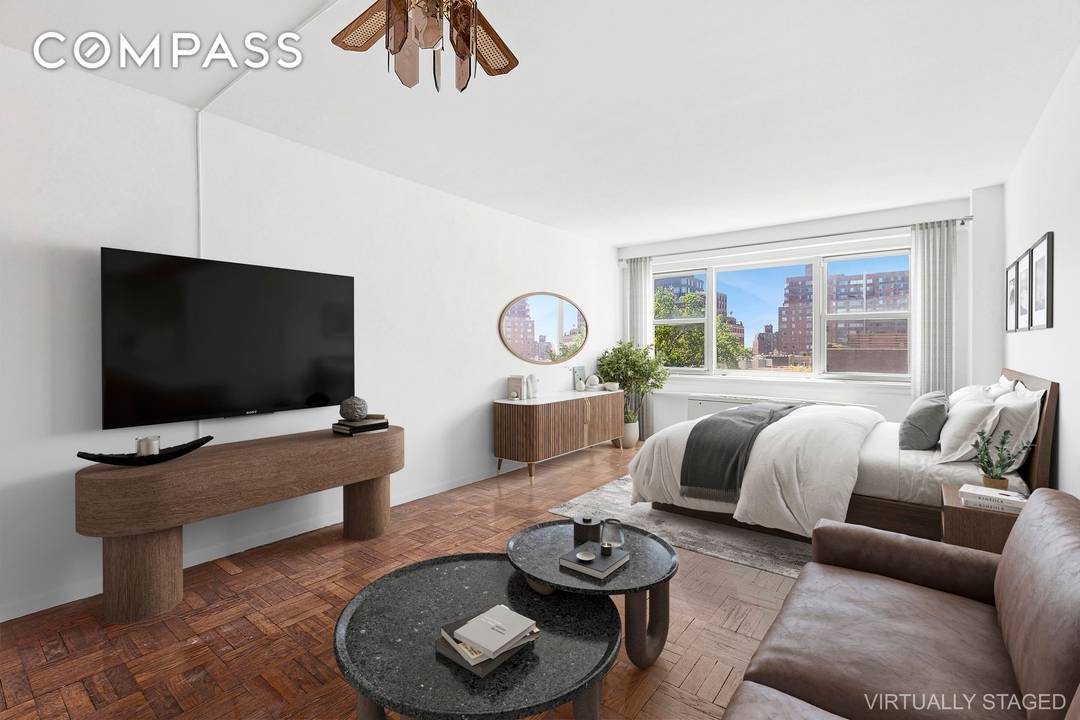 High floor, bright, spacious city view studio at the full service John Adams in the heart of Greenwich Village.