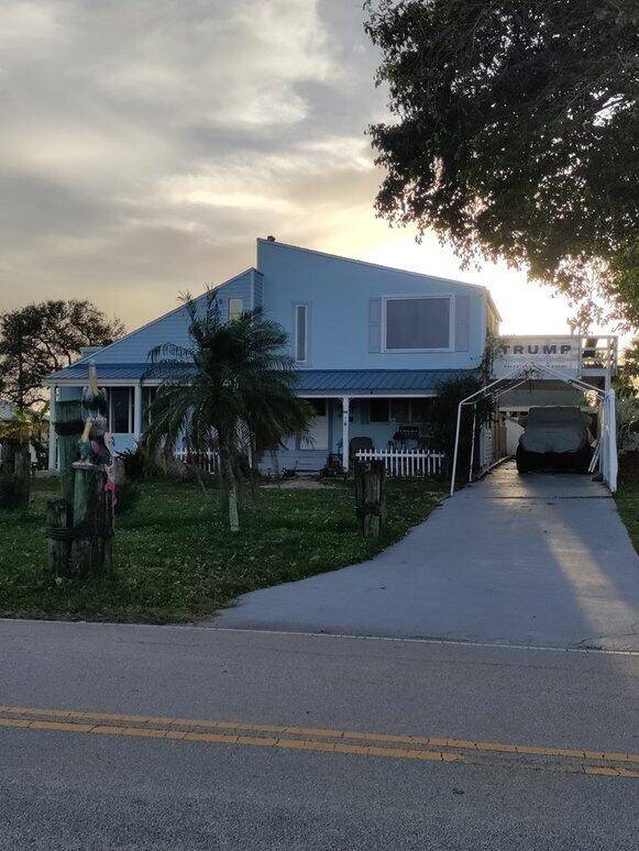 Two story pool home with dock, boat house and guest house over looking the Indian River.