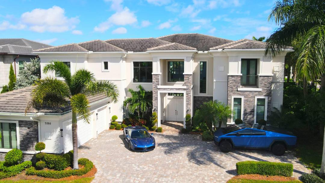 Discover refined living in this FULLY FURNISHED designer estate on an exclusive corner lot in Royal Palm Polo, Boca Raton's most coveted gated community.