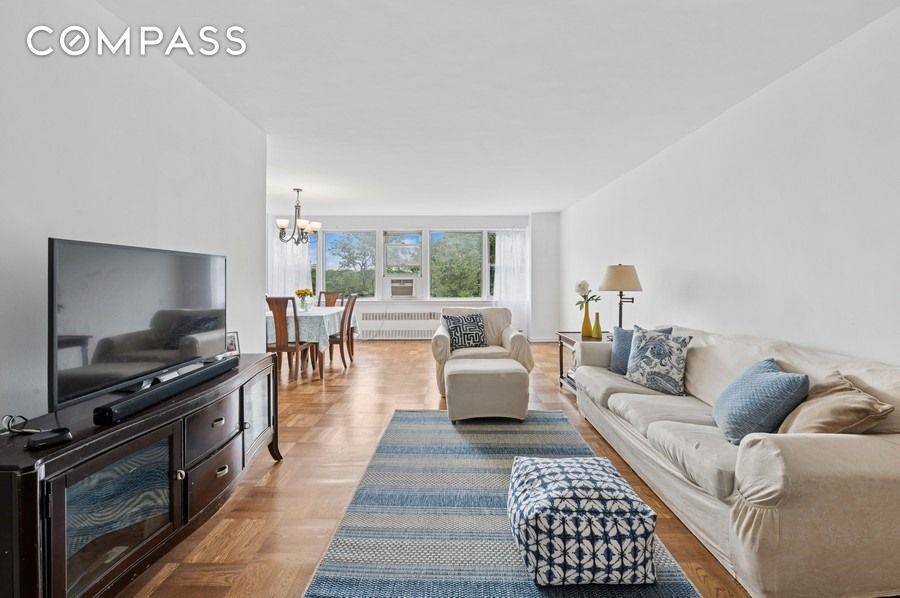 Perched high on a hill with ten eastern facing windows, this lovely two bedroom, one and a half bath home, is flooded with light and verdant views.