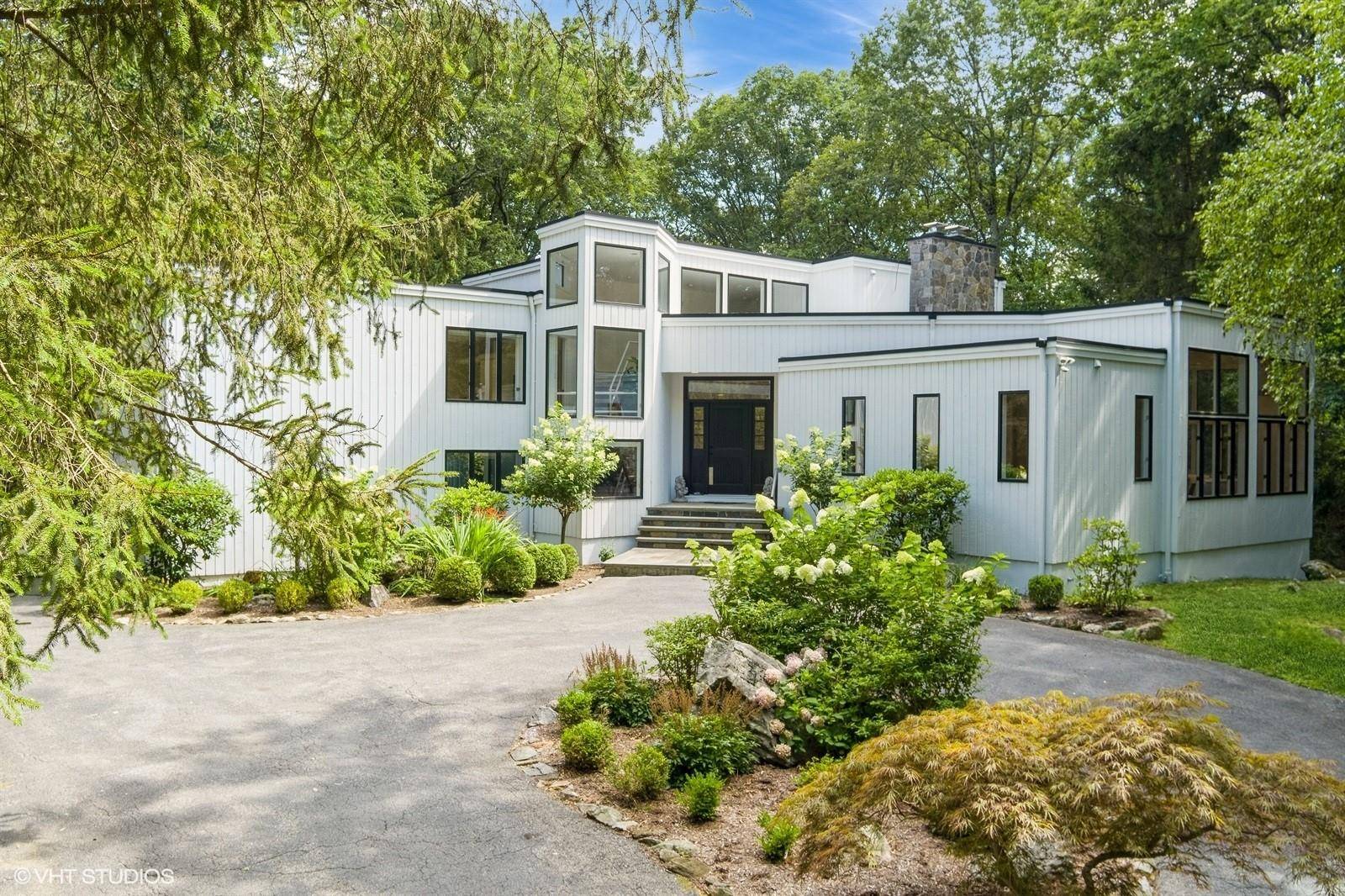 Welcome to this sleek, light filled Contemporary in Armonk, where openness and design converge on 2.