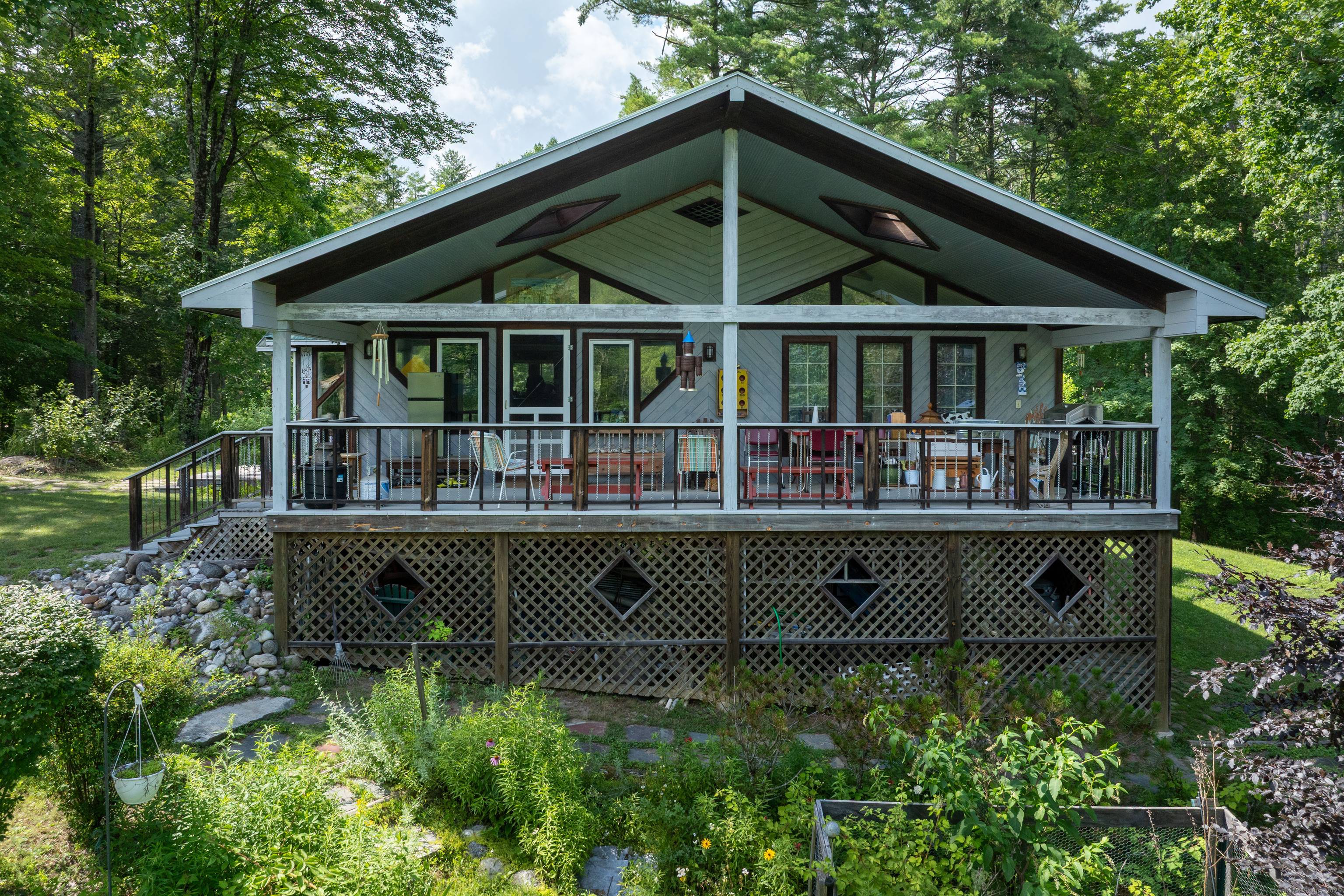 Tucked away on a private road with shared lake access to the serene waters of Lake Washinee, this custom one level home offers the perfect blend of natural beauty, thoughtful ...
