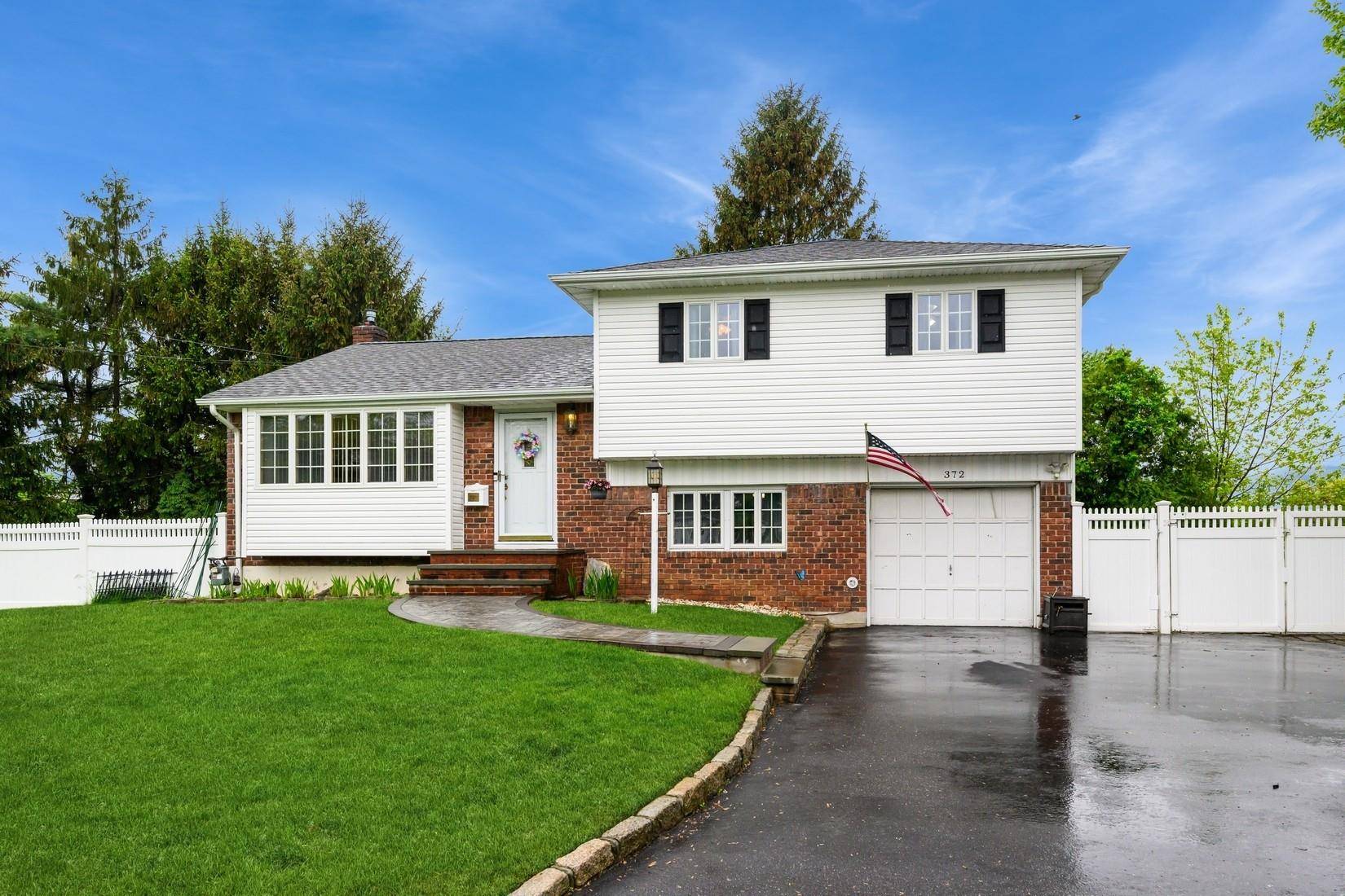 West Islip Gem ! This turn key, move in ready Renovated Split Ranch features 3 bedrooms, 1 full bath, 2 half baths, with an open layout, perfect for modern living.