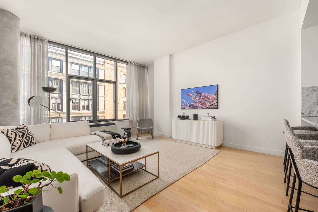 This spectacular two bedroom, two bath home is ideally situated at the crossroads of SoHo and NoLita, offering sweeping open city views with stunning eastern exposure overlooking the Williamsburg Bridge.