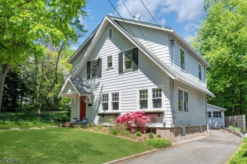 Charming craftsman cottage home with gorgeous kitchen and island opening to the brightly lit living room featuring a lovely wood burning fireplace.