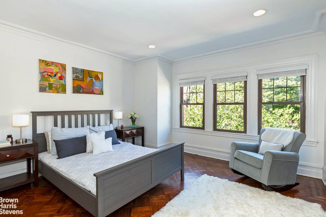 This three story, flexible four to six bedroom home is designed in the Neo Tudor style and includes a full finished basement.