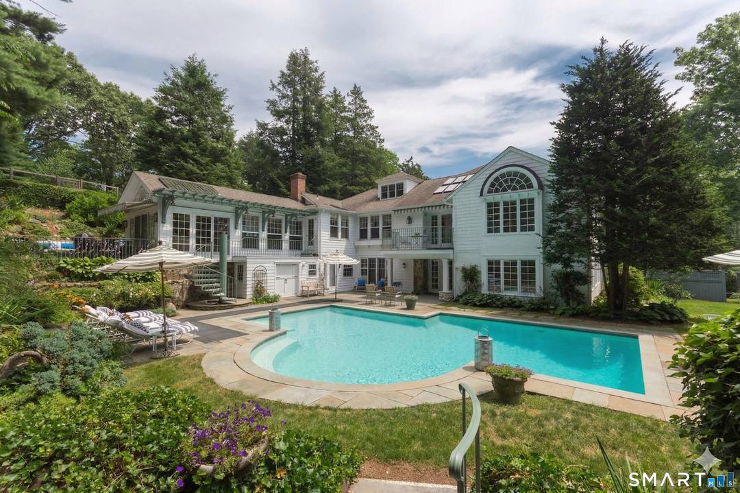 Few homes in Darien offer this combination five bedrooms, five indoor entertainment spaces, a private elevator, gunite pool, hot tub, and pool cabana with wet bar all on a private.