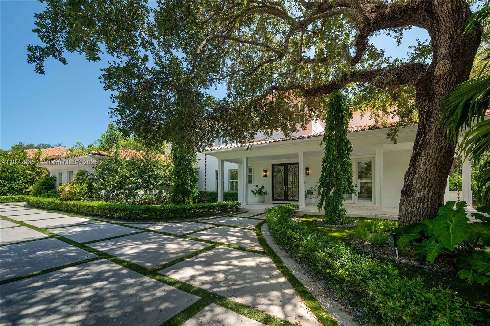 Welcome to this stunning and elegantly appointed residence nestled in Coral Gables prestigious Cutler Oaks Estates.