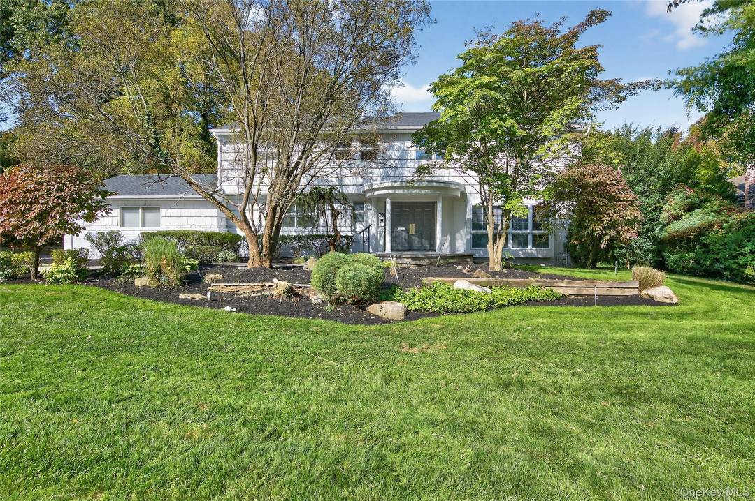 Elegant Expanded Royal Model Center Hall Colonial in Lakeville Estates, East Hills, set on just shy of a half acre in one of the community s most prestigious enclaves.