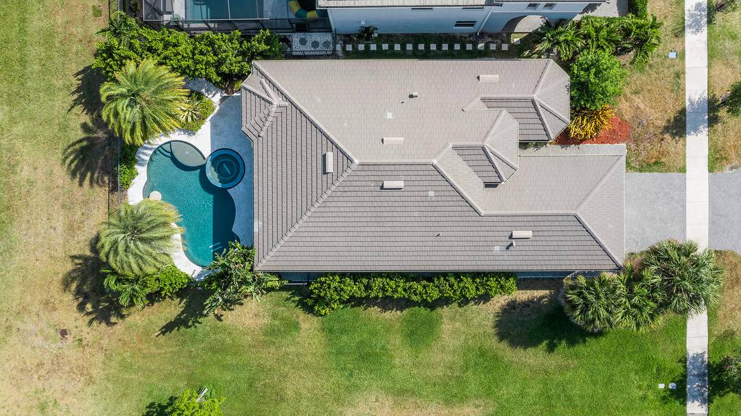 Located in the desirable Hammocks community of Westlake, this beautiful lakefront home offers luxury living with its own private heated pool and peaceful water views.