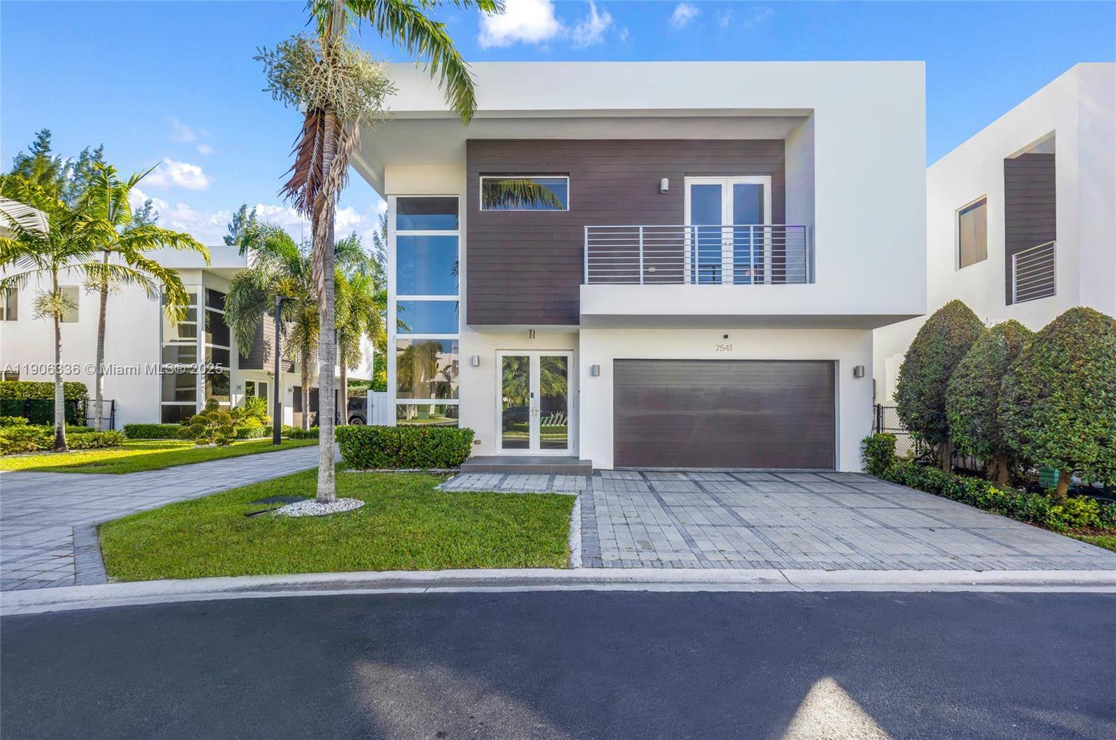 Beautiful CORNER home in Modern Doral 45 with no rear neighbors and tranquil views of lush trees.