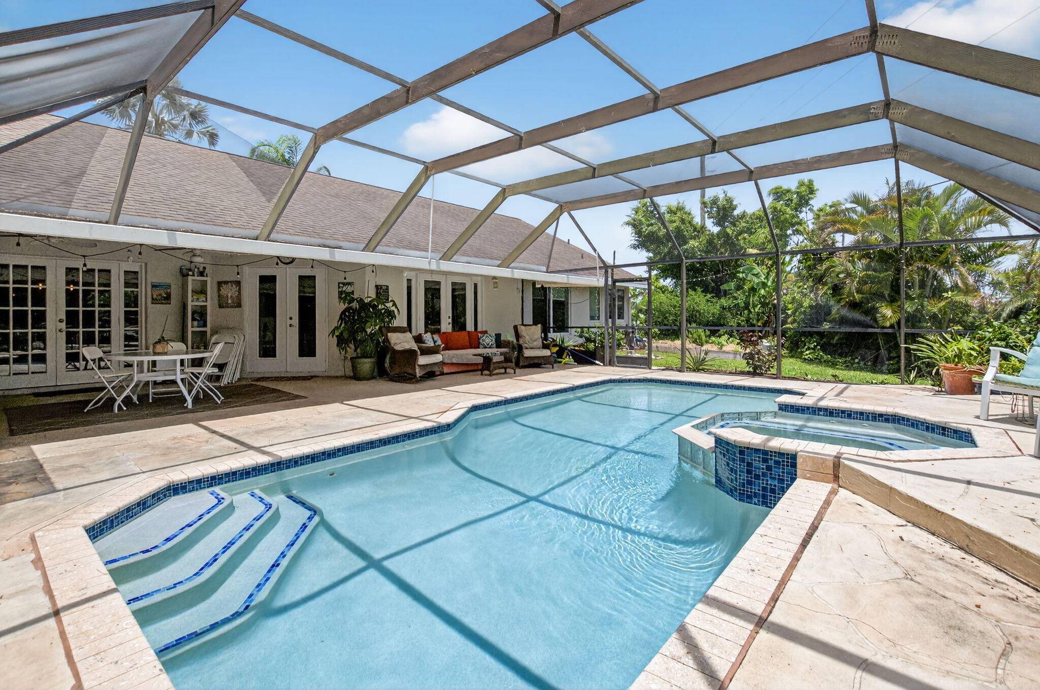 Stunning 3BR 2B bonus home office home gym, screen enclosed pool home sits on a 1 4 acre pie shaped fenced cul de sac lot.