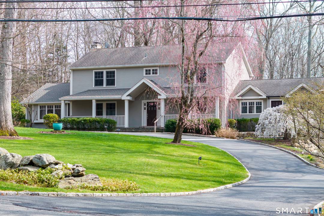 Discover this distinctive Colonial, gracefully positioned on a quiet cul de sac with 2 acres of stunning natural beauty.