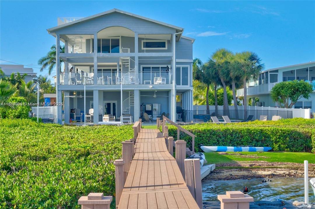 Paradise awaits in this elegant bayfront home in Buccaneer Point.