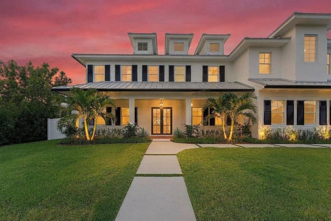 Welcome to 11823 Lakeshore Place, a stunning custom built waterfront estate nestled within the exclusive gated community of Hidden Key in Palm Beach Gardens.