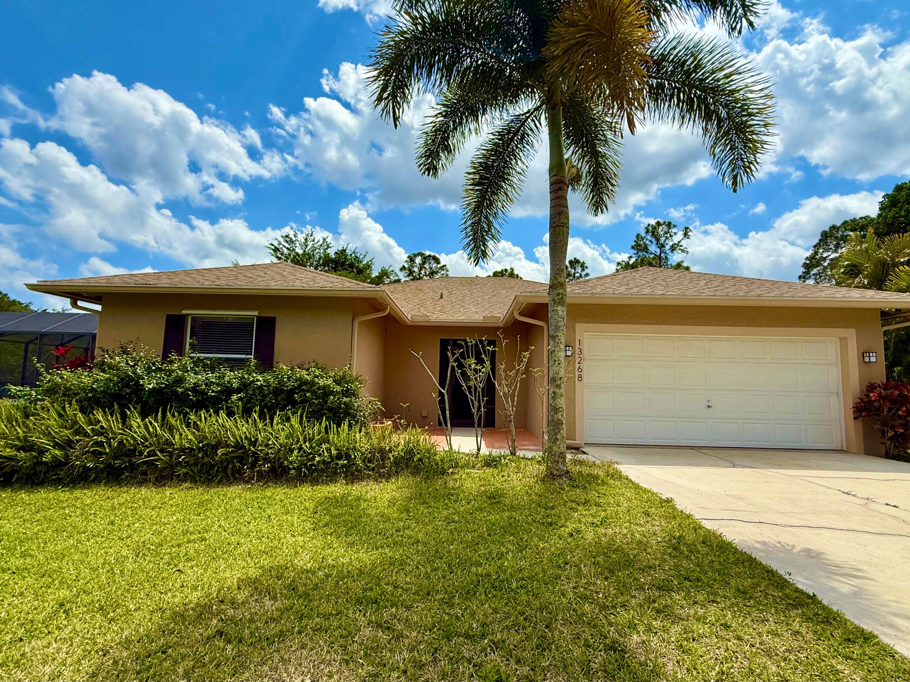 CBS 3 bedroom 2 1 2 bathroom 2 car garage POOL home on over an acre AND on a paved road in Jupiter Farms.
