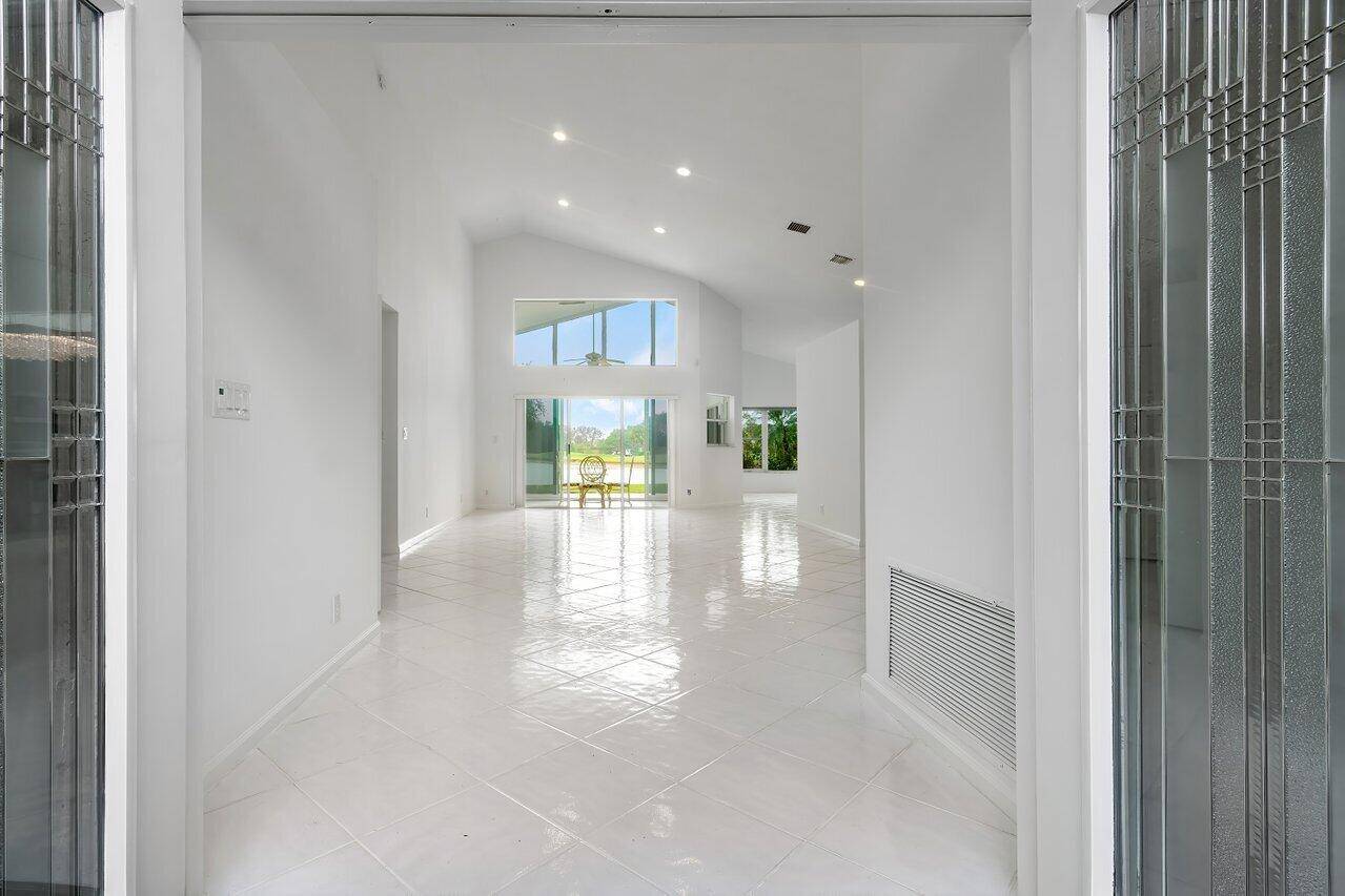Step into luxury through the elegant double glass entry doors of this custom home, boasting just under 2200 sqft of living space with breathtaking lake and golf course views.