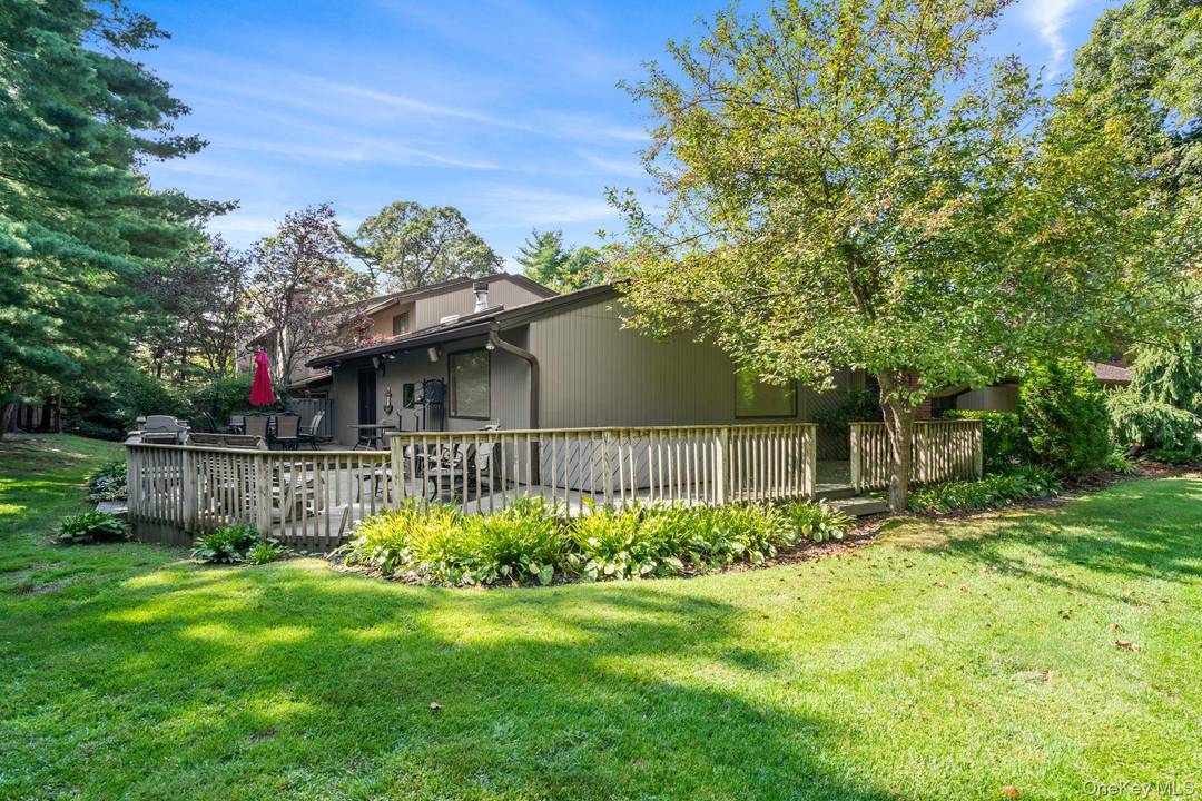 Surrounded by expansive greenery and a wrap around Trex deck, 234 Hamlet Drive is an end unit Ranch with three bedrooms and two and a half baths.