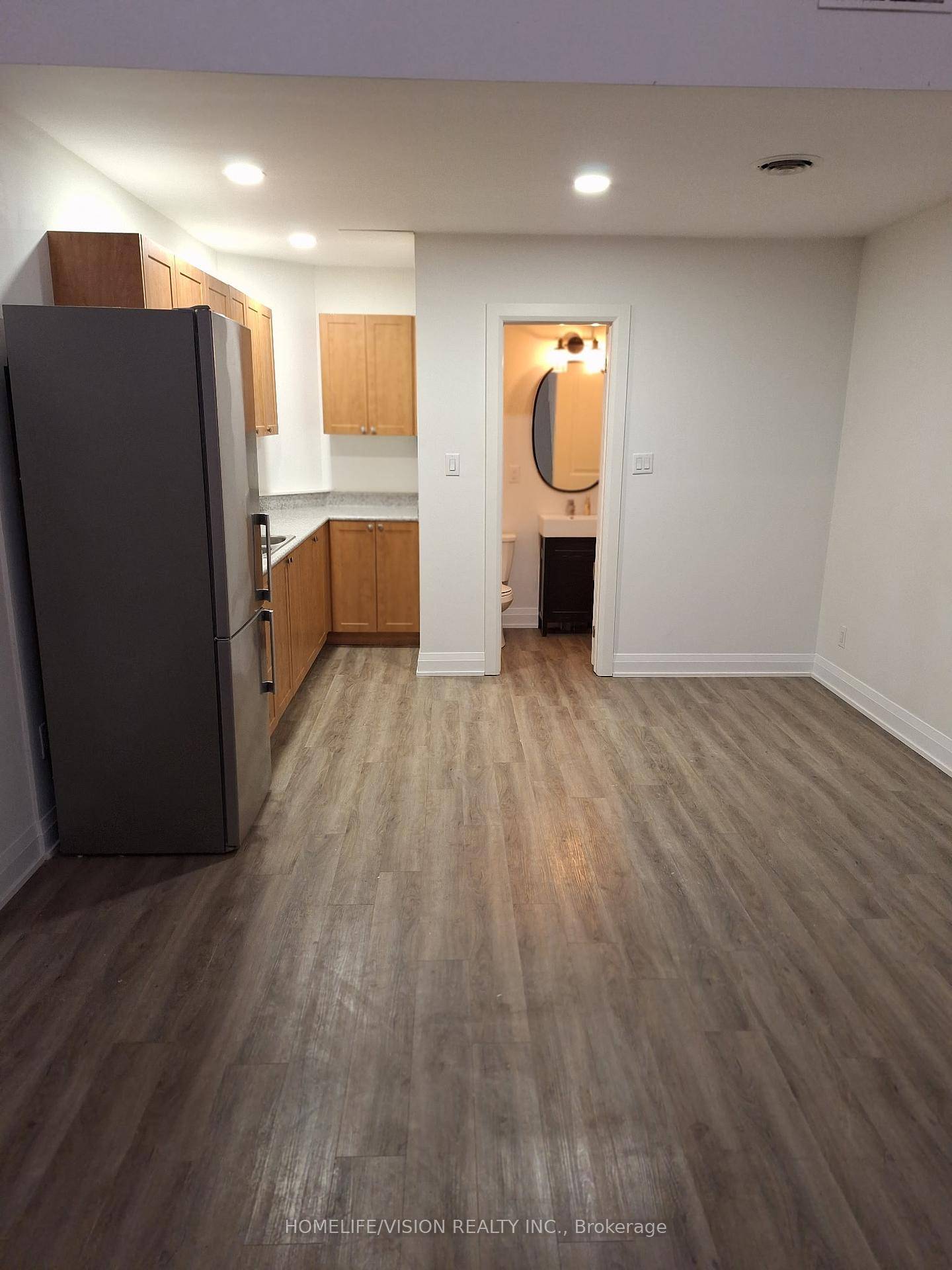 loft apartment with fridge, pot lights and newer laminate flooring can put in couch, chair and t.