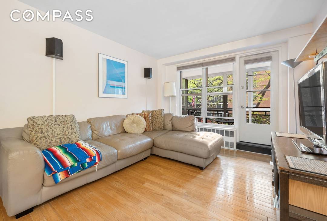 Apartment 2E is a warm, inviting, updated home that is great for entertaining, with its open kitchen and recently installed stainless steel appliances.