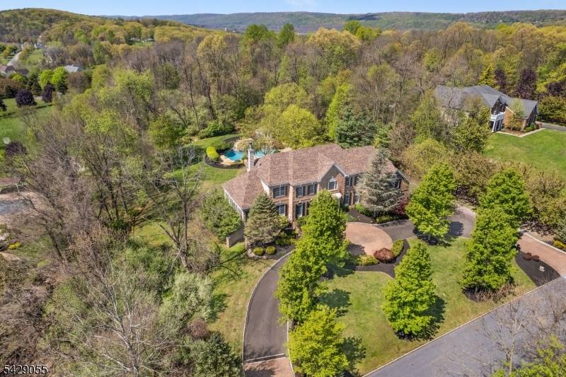 Utterly captivating brick front Custom Colonial personifies elegance sophistication set back beautifully from the road on a cul de sac in sought after neighborhood.