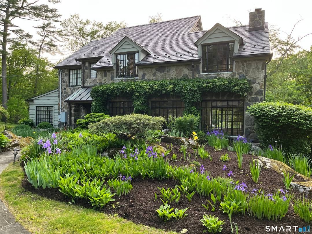 Set gracefully above the scenic Goodwives River, this exceptional 1930s stone residence blends timeless character with 3403sq ft of sophisticated modern updates.