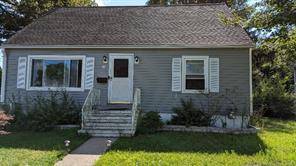 Cozy Cape with huge potential in a tree lined neighborhood.