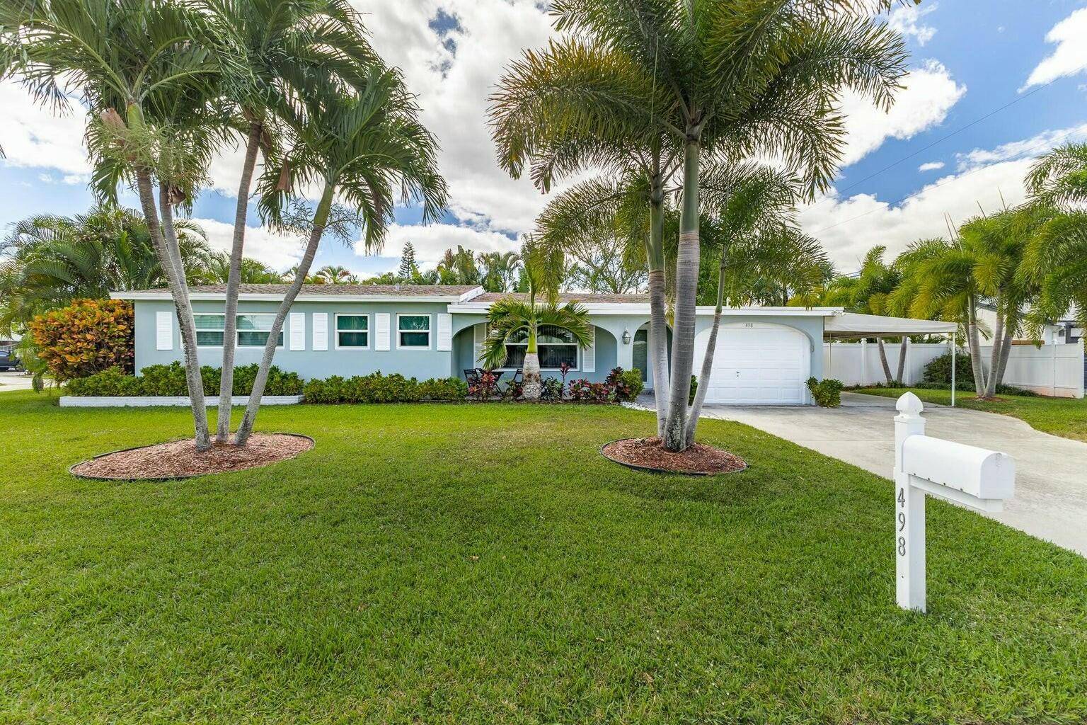 Beautiful East Boca pool home situated on an oversized corner lot, conveniently located only one mile from the beach !