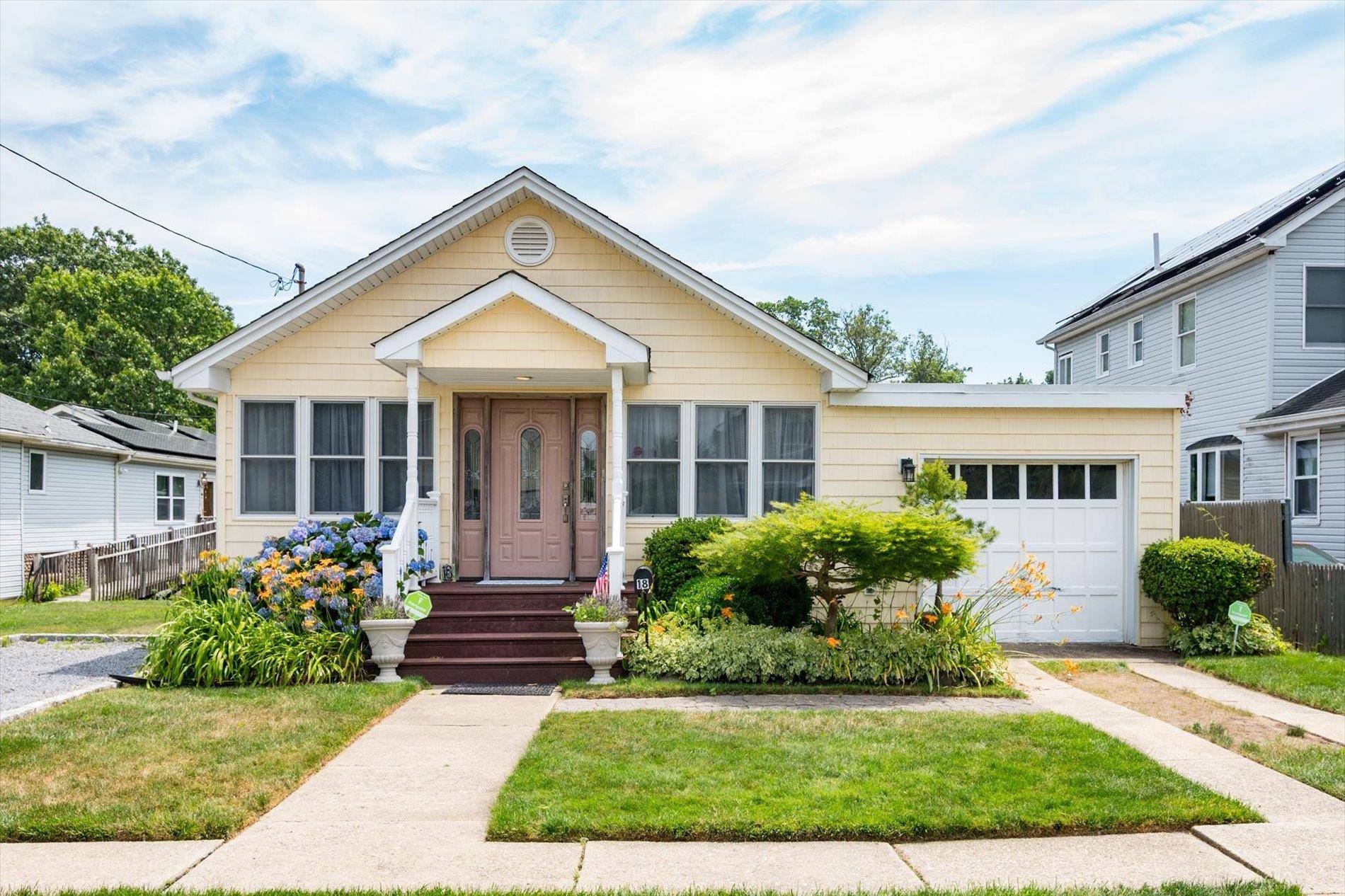 Welcome to this charming Farmingdale gem, where warmth and character fill every corner of this thoughtfully updated home.