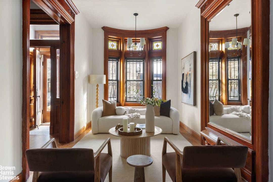 A grand townhouse defined by scale, light, and extraordinary original craftsmanship, this five bedroom residence with flexible potential for seven bedrooms delivers classic Harlem elegance at its most refined.