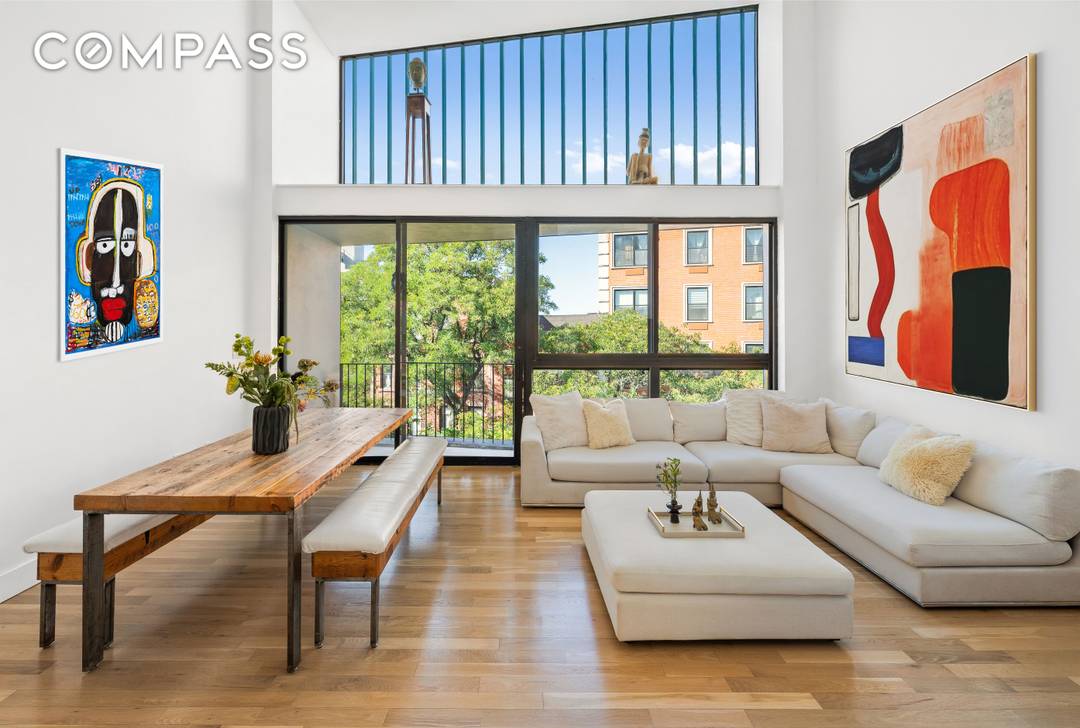 A rare architectural duplex with 24 foot ceilings, panoramic skyline views, and three private balconies available now in Prime Fort Greene.