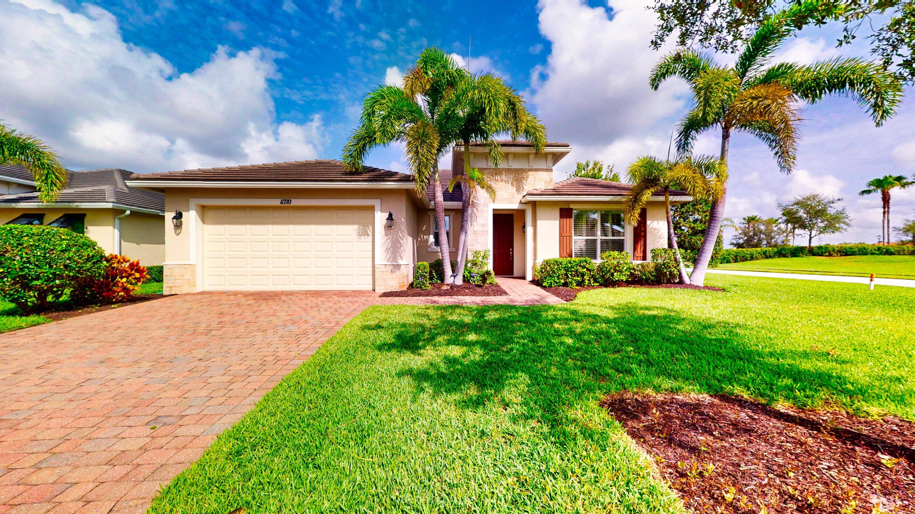 Located on a beautifully landscaped corner lot, this spacious 2 bedroom, 2.