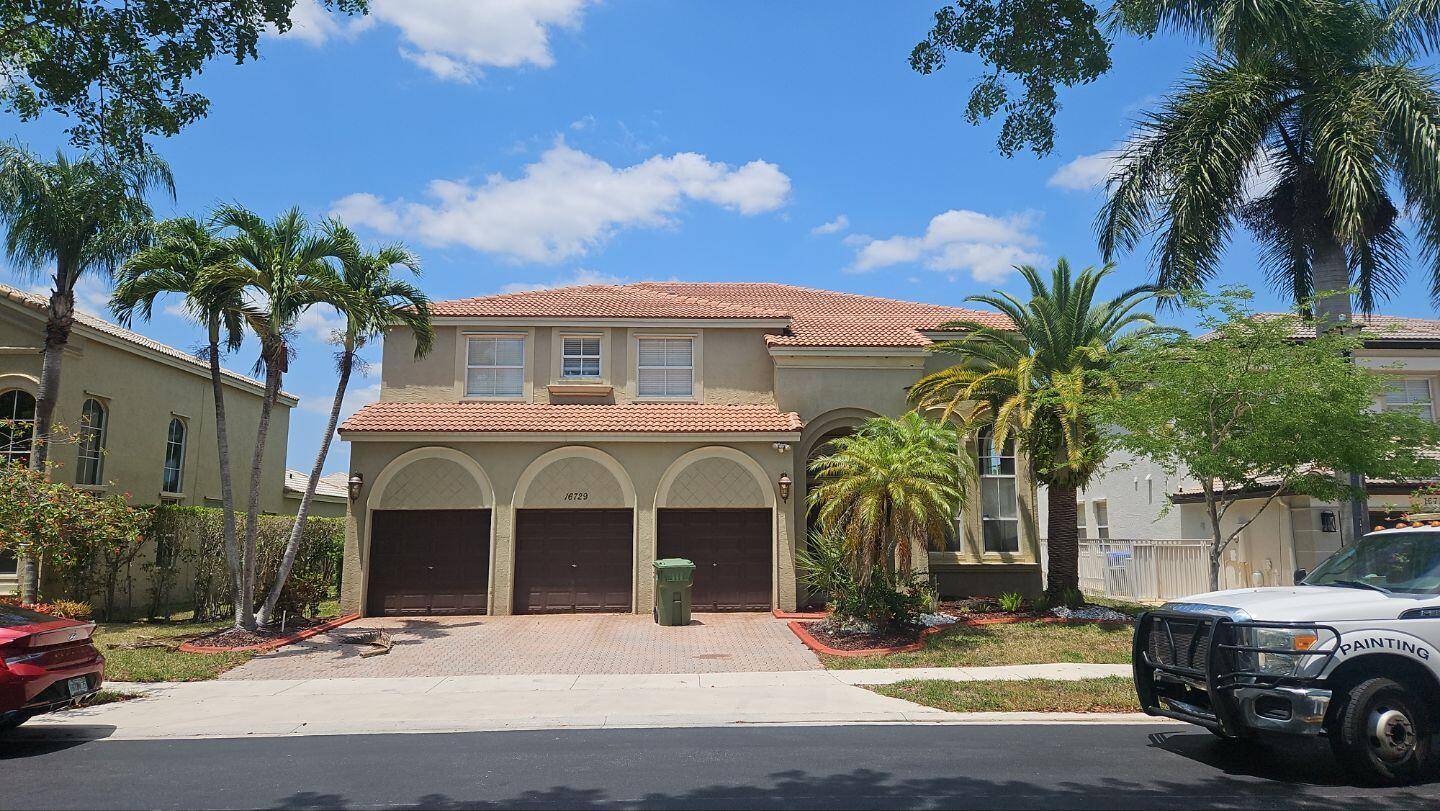 Lovely two story home on a community lake with a three car garage.