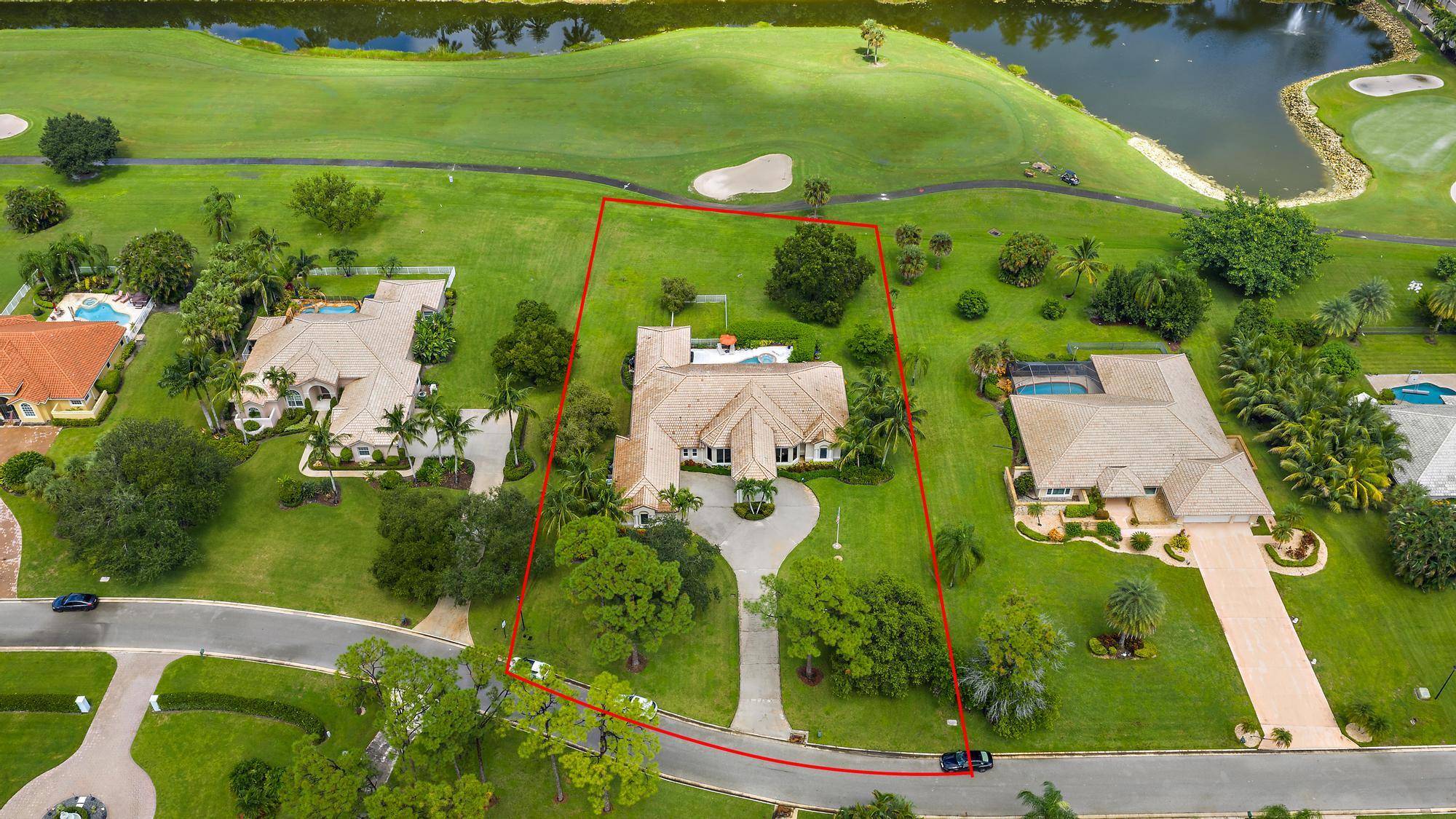 Set on over an acre of lush, manicured grounds with sweeping views of the 9th holeof the PGA National Estate Golf Course, this stately residence in Bay Hill Estatescombines timeless ...