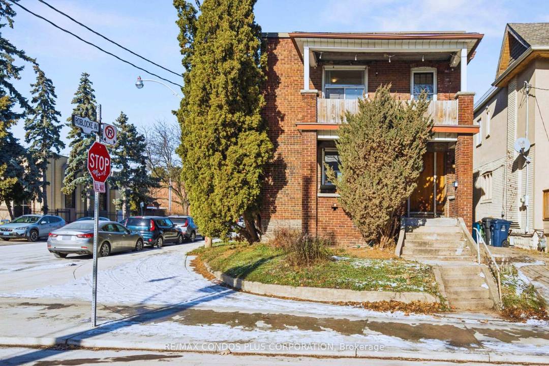 Impressive detached duplex with two car garage detached on a large corner lot in trendy Dovercourt Village, ideal for families or investors.