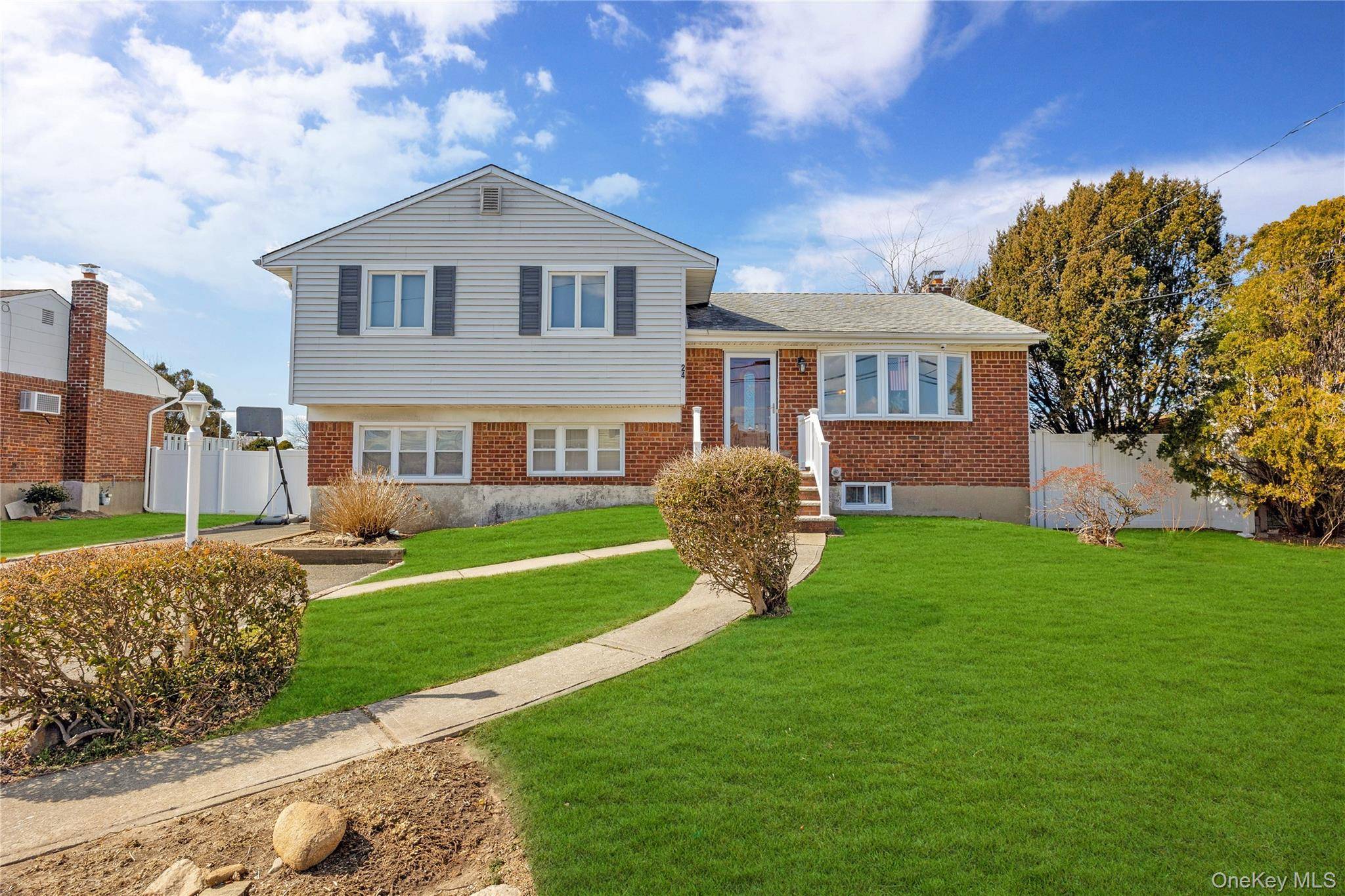 Welcome to this beautifully maintained expanded split level home in a prime Hicksville location, offering 3 spacious bedrooms and 2 full baths.