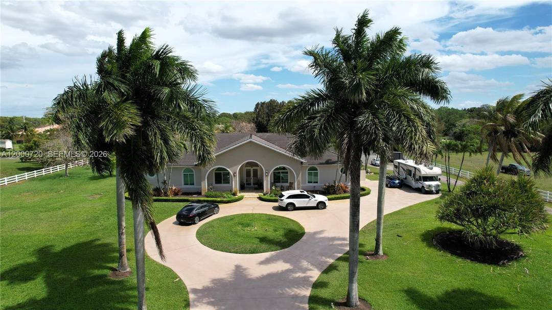 Experience the ultimate 'rural oasis' on this stunning 5 bedroom, 3 1 2 bath Southwest Ranches estate on 2.