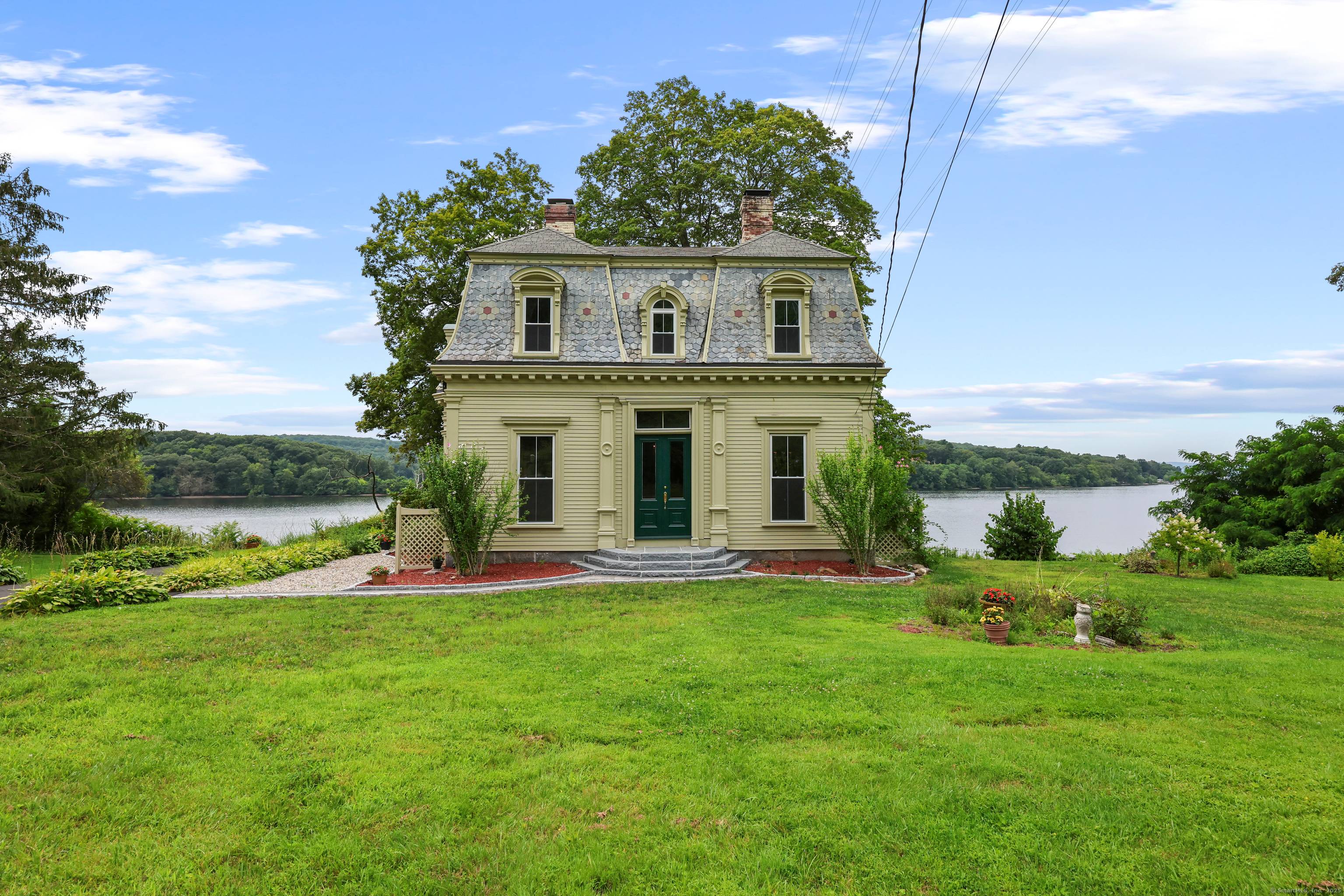 The striking David Watrous house, located on the CT river, offers unobstructed views of the river where it merges with the Salmon river from every room.