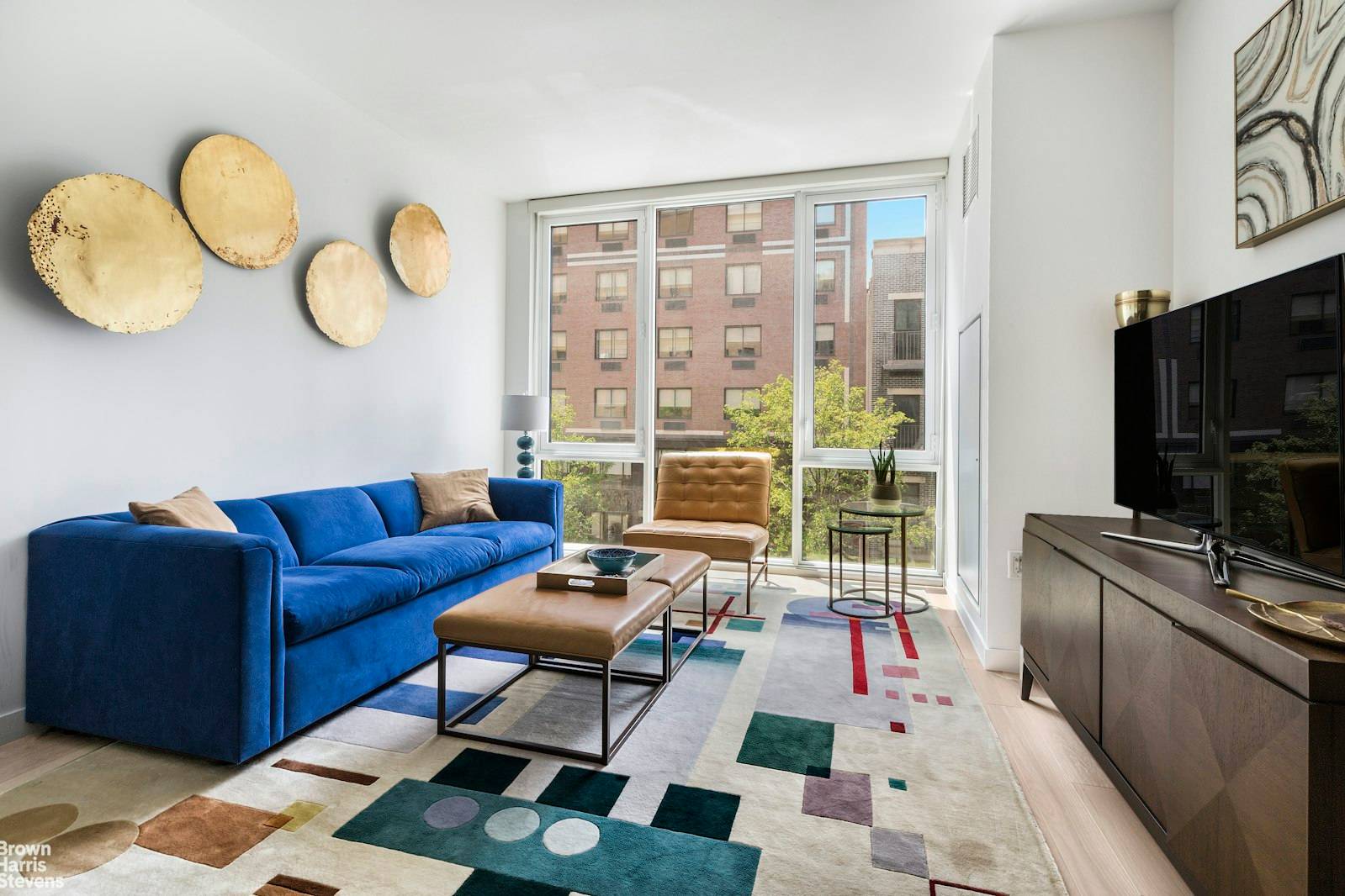 Sunny 1bed 1bath condo with southern exposure, floor to ceiling windows, Miele washer dryer, central heat air, open kitchen with high end appliances, and glass backsplash.