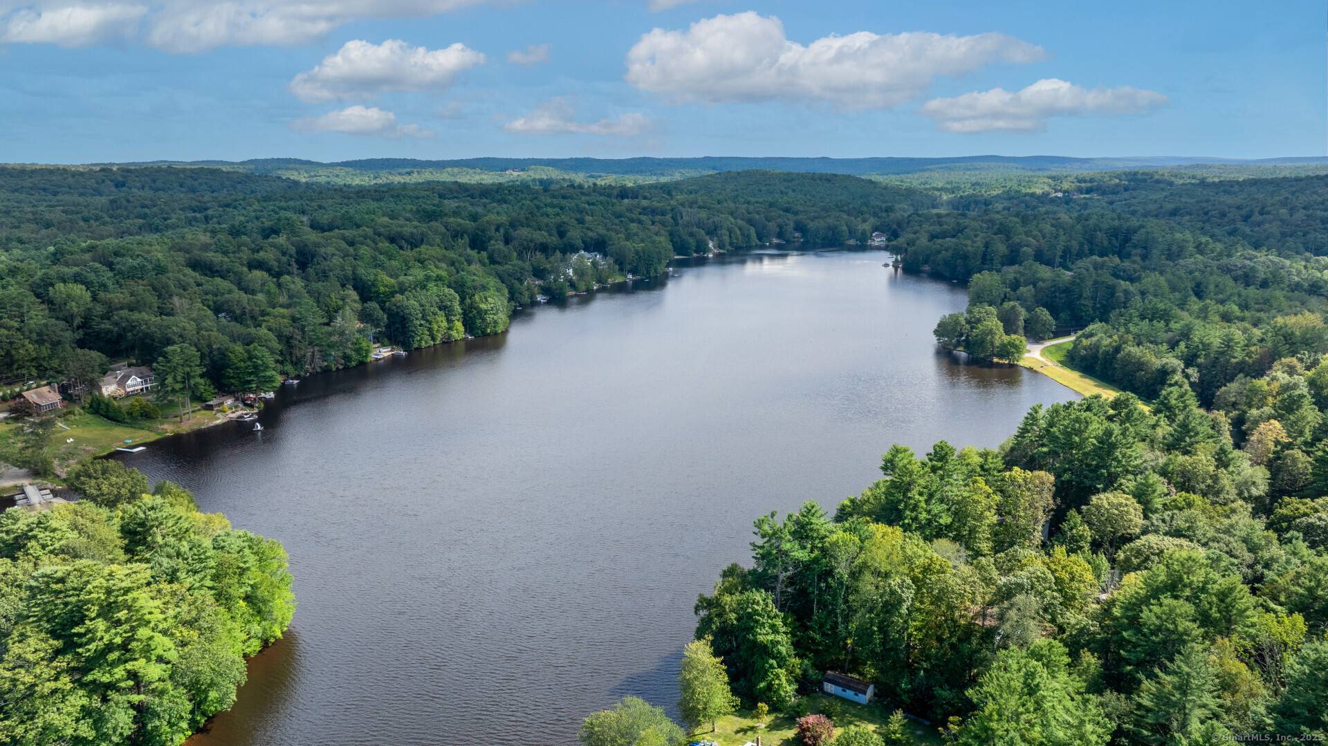 This charming, year round lake front home located at 115 Crooked Trail Ext in Woodstock, CT was built in 1986 and offers a cozy and inviting atmosphere.