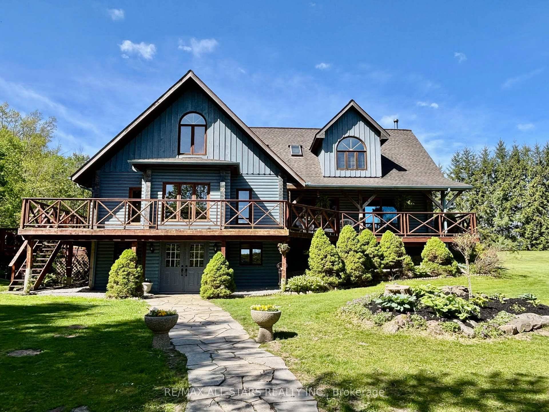 Situated on a quiet country road and surrounded by nature, this custom log home offers a rare combination of rustic charm and refined living on a breathtaking 9 acre estate.