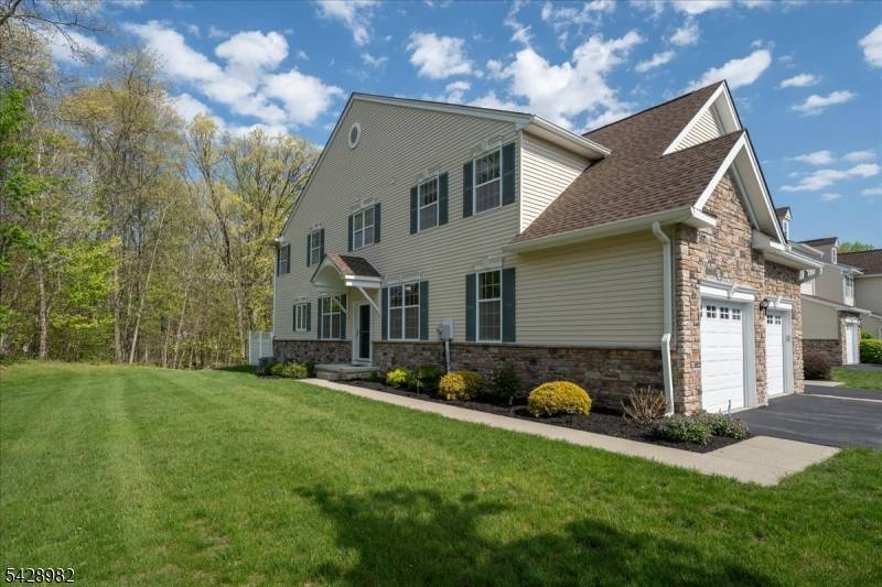 Better than new end unit townhome with a two car garage, ideally situated on a beautiful level lot at the end of a quiet cul de sac backing serene woods.